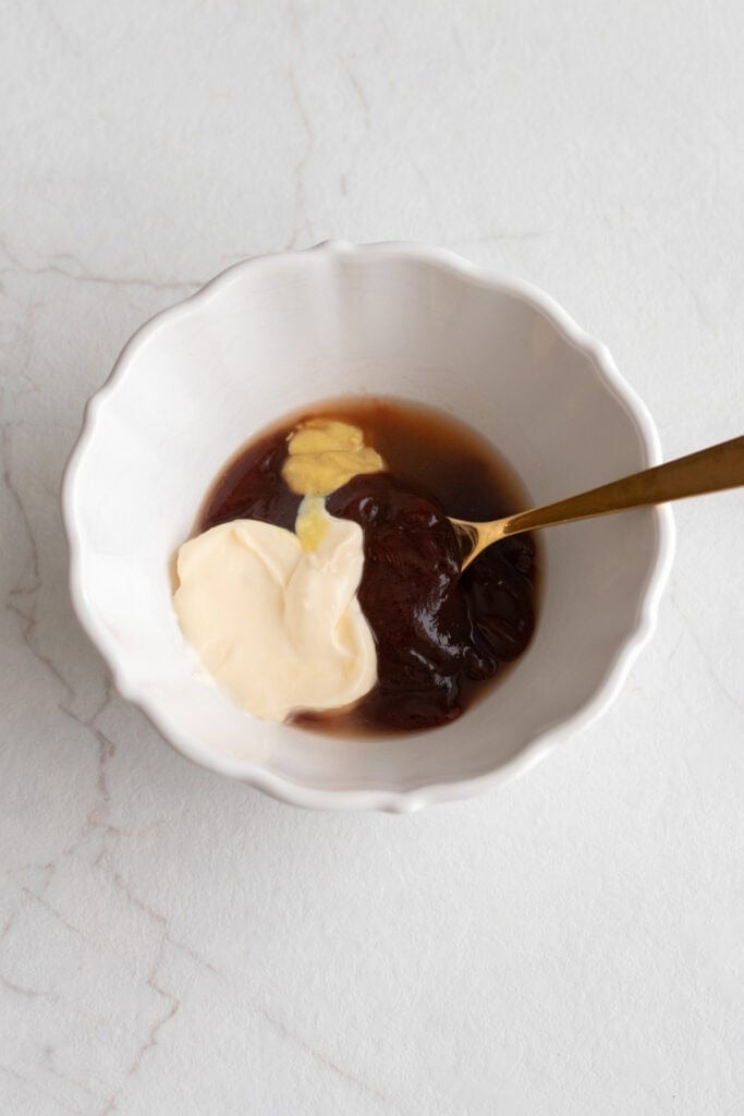 Sauce ingredients in a bowl with a spoon.