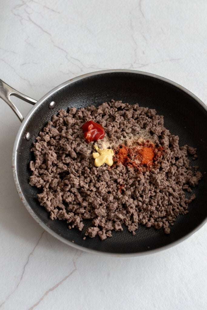 Ground beef browned in a skillet with spices.