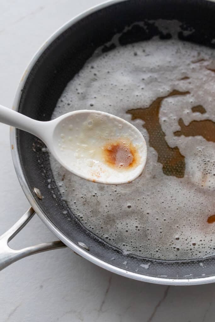 Making sage butter sauce in a skillet.