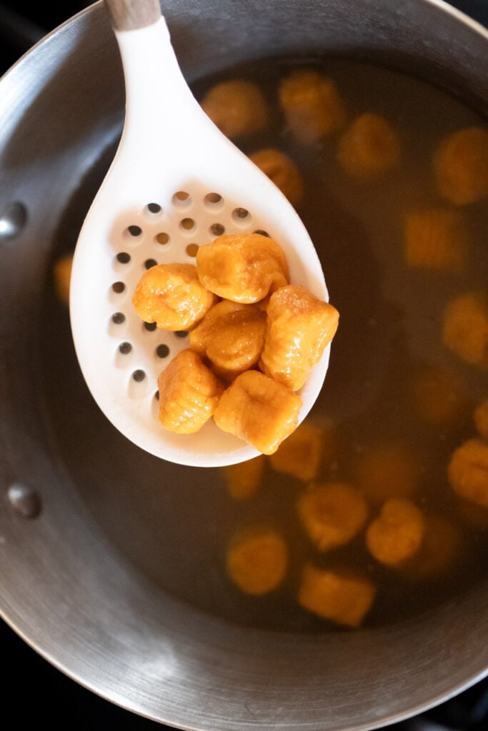 Boiling gnocchi in a pot of water.