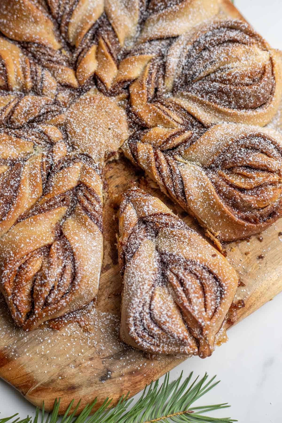 A baked sourdough cinnamon star dusted with powdered sugar.