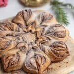 a sourdough cinnamon star bread on a cutting board on the counter.
