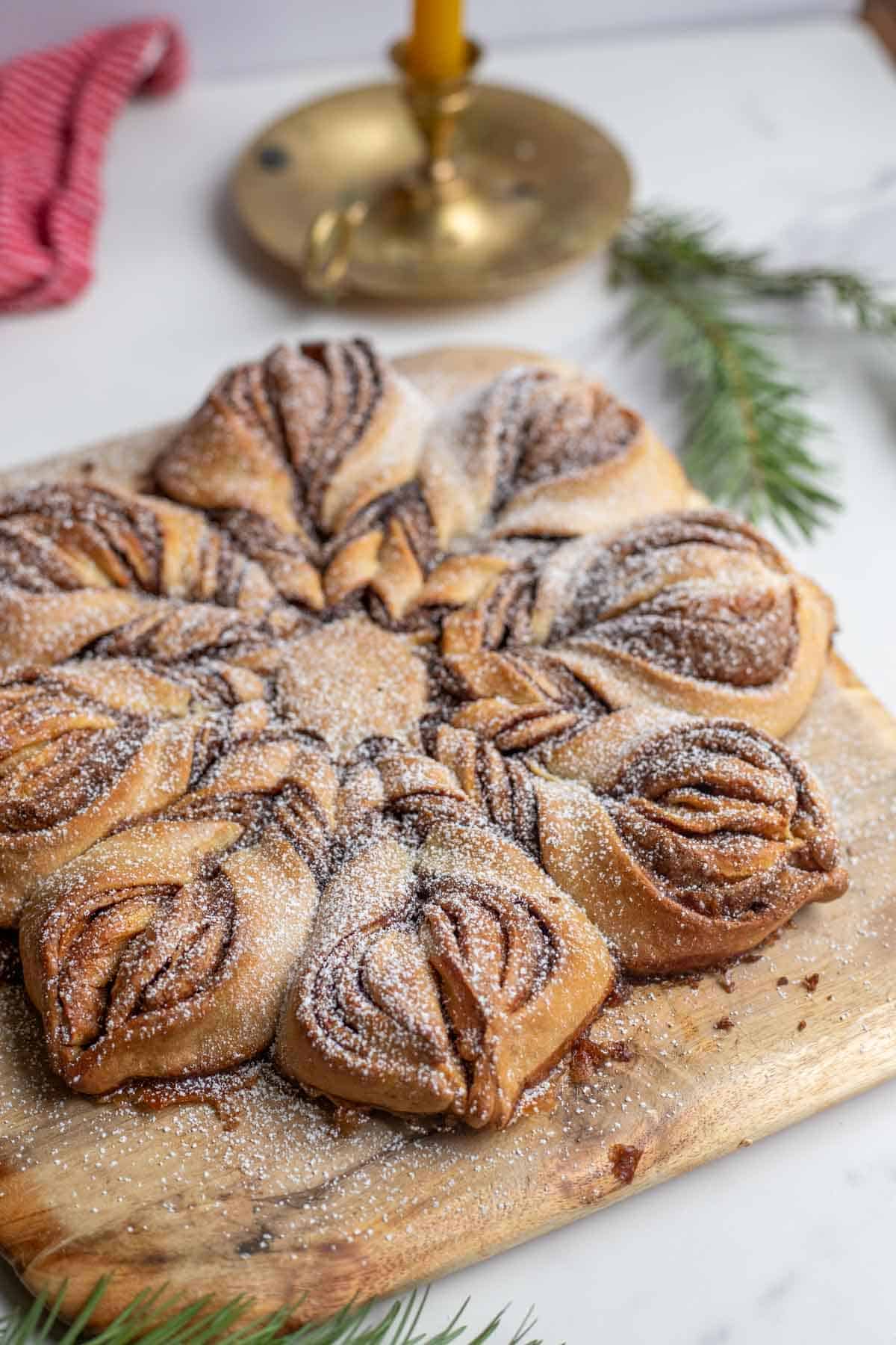 A sourdough cinnamon star bread on a cutting board on the counter.