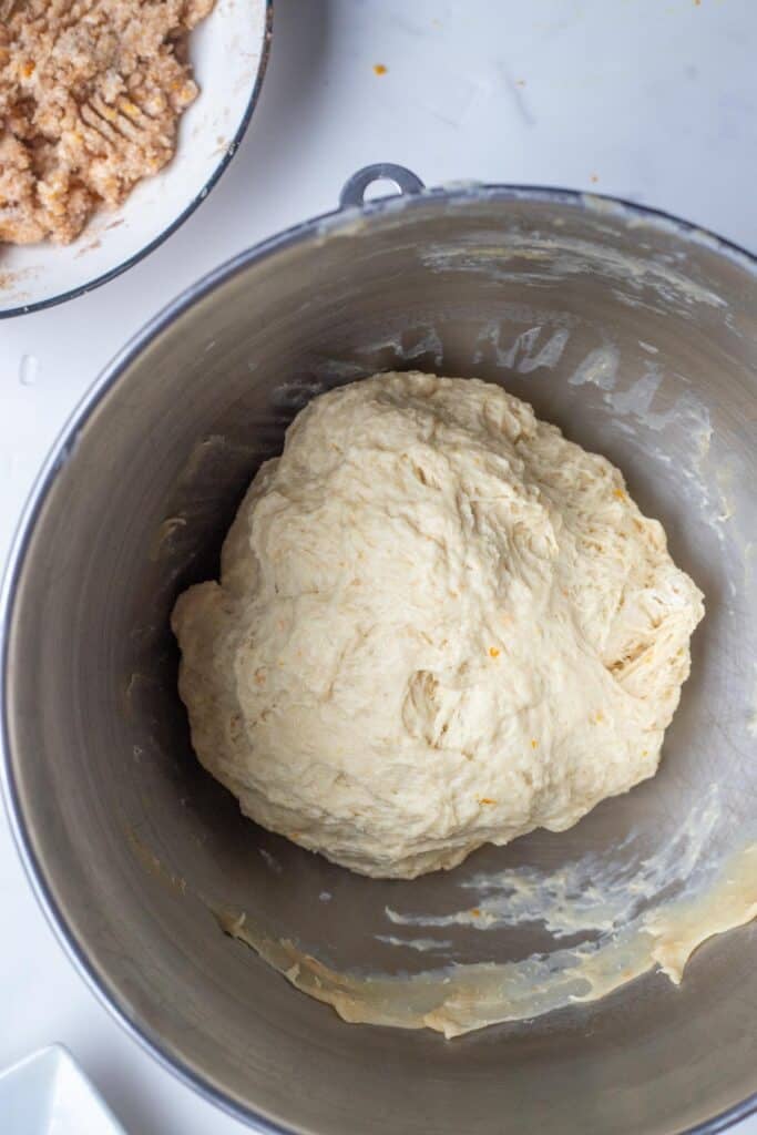 A kneaded ball of sourdough in a stainless steel mixing bowl.