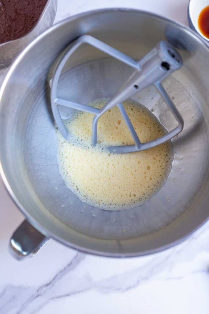 Eggs and vanilla whisked together in a stand mixer until frothy.