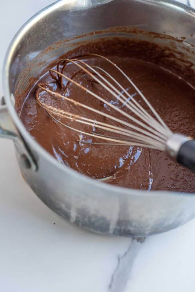 Sugar, chocolate chips, and butter whisked in a saucepan until melted.