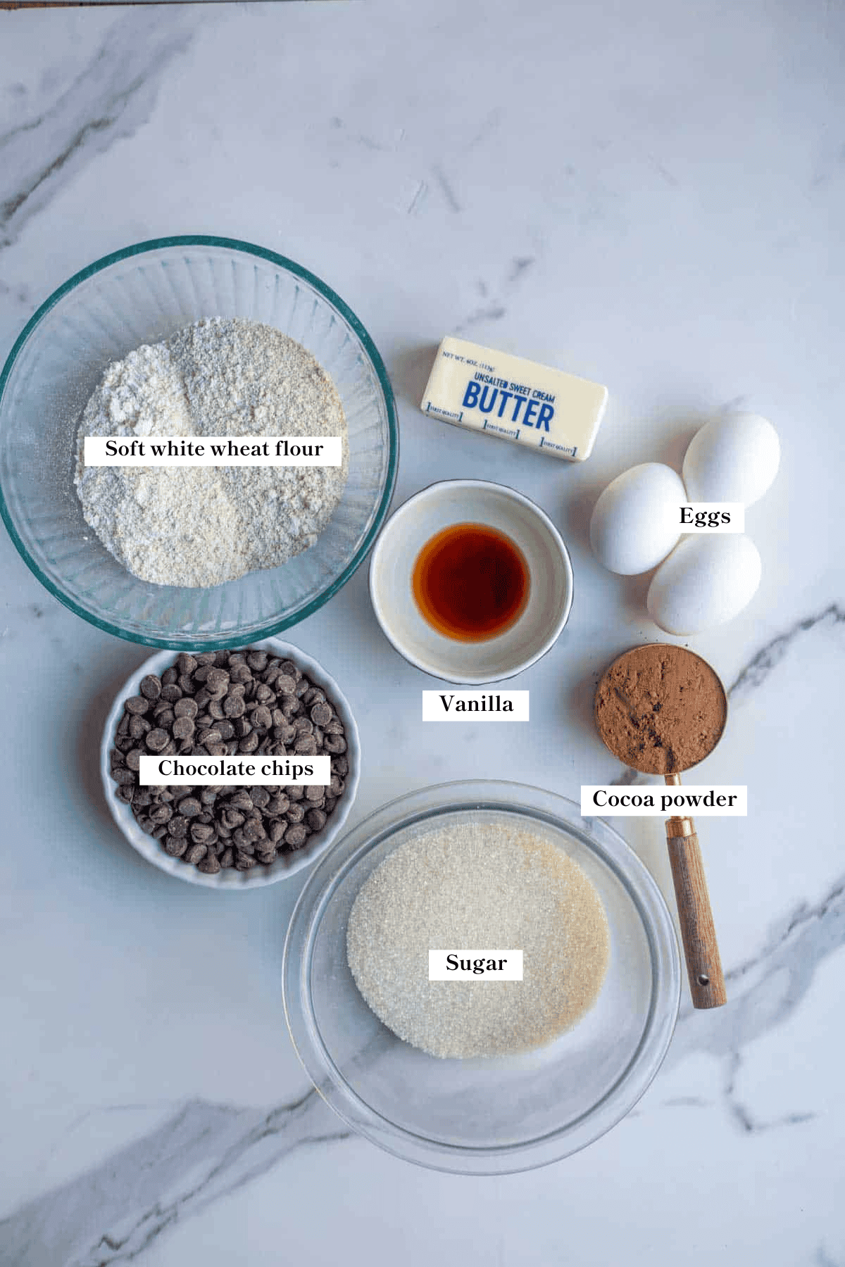 Ingredients for whole wheat brownies on a marble counter top.