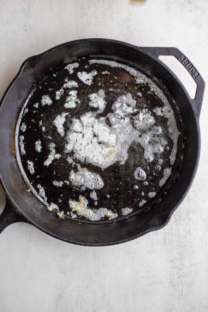 Melted butter in a cast iron skillet.
