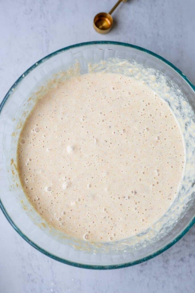 Whole wheat pancake batter in a glass bowl resting.