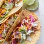 Chicken taos on a plate.