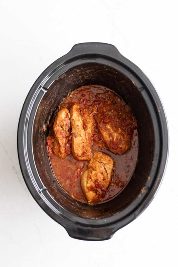 Cooked chicken in a crockpot.