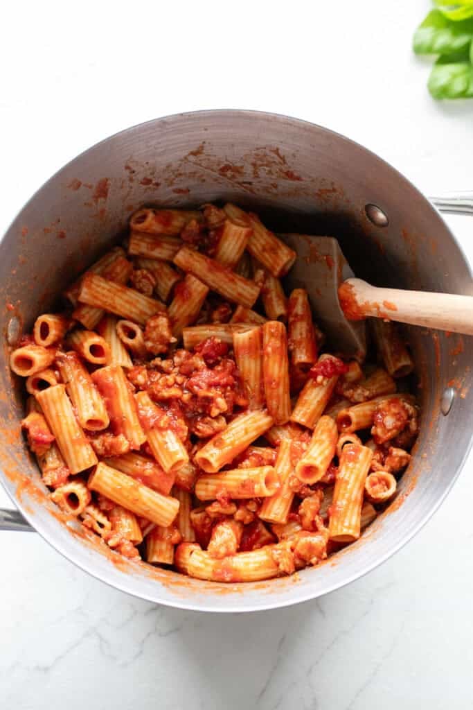 Pasta mixed with marinara.