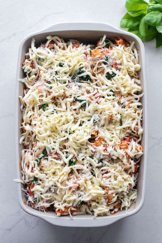 Casserole dish with pasta covered in cheese.