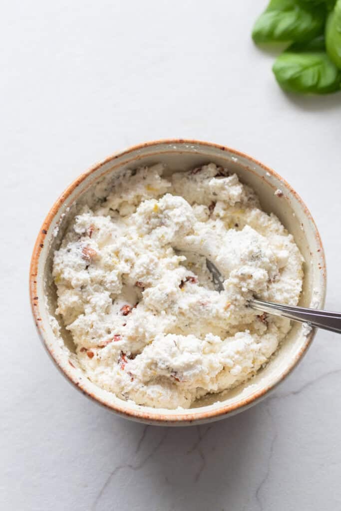 A small bowl with a cheese mixture.