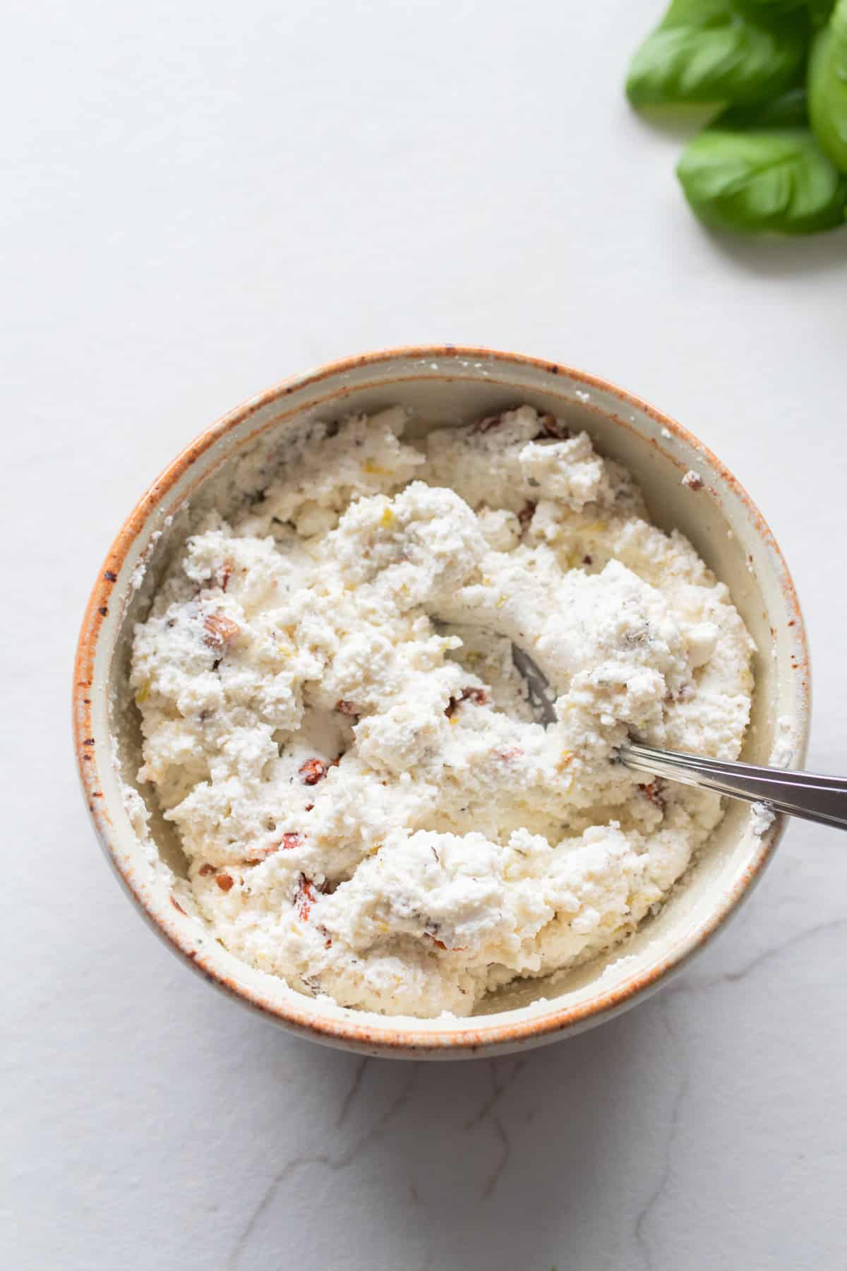 A small bowl with a cheese mixture.