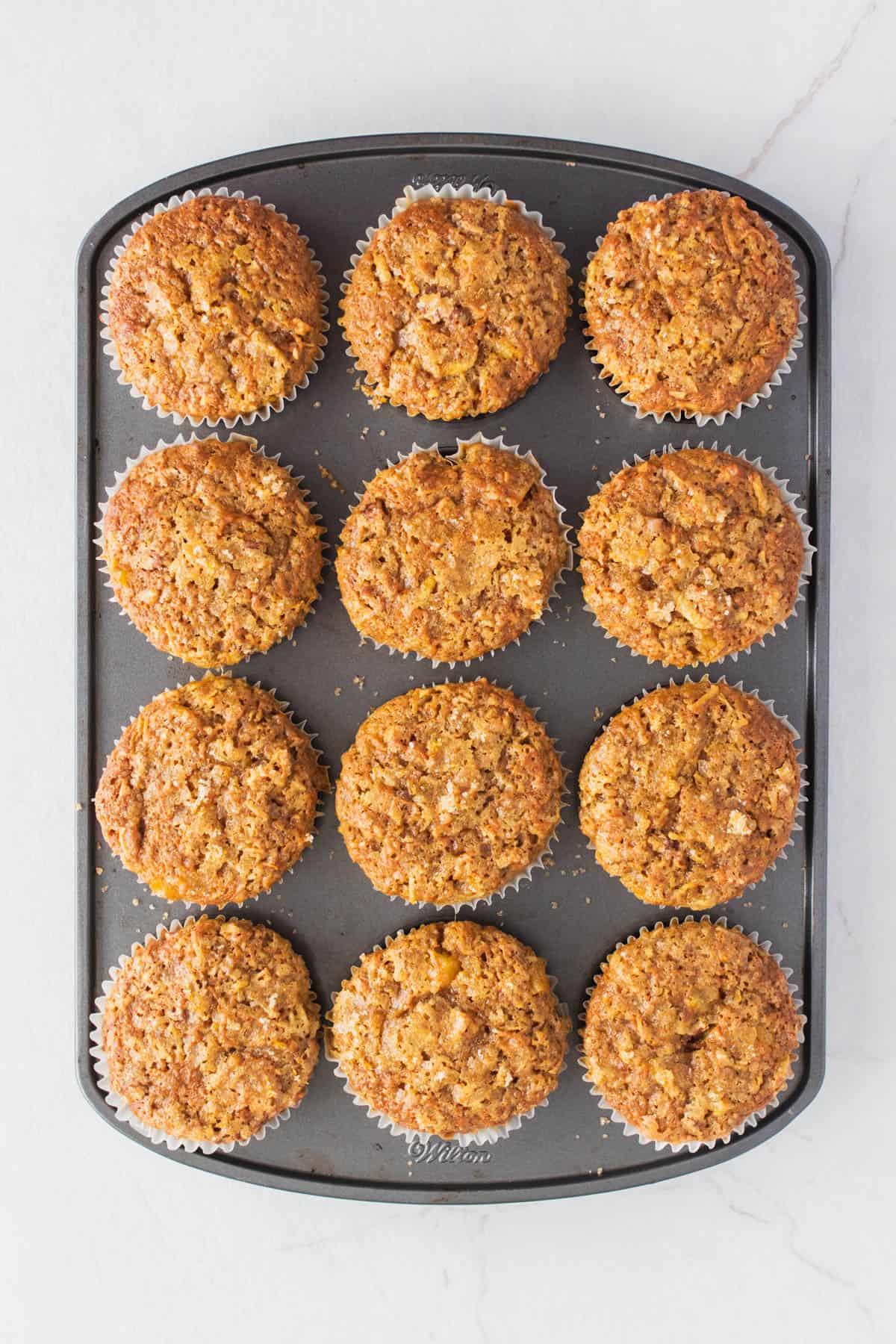 A muffin tin filled with baked muffins.