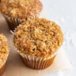 4 morning glory muffins on a baking pan.