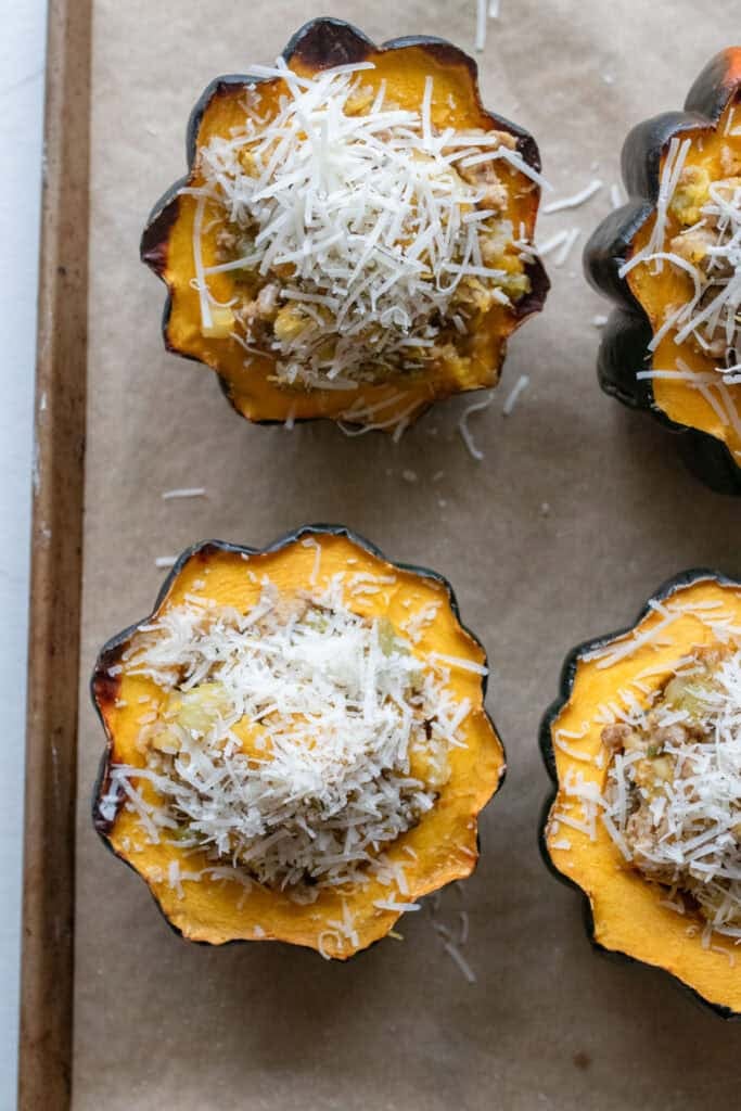 Acorn squash with sausage filling and parmesan cheese.