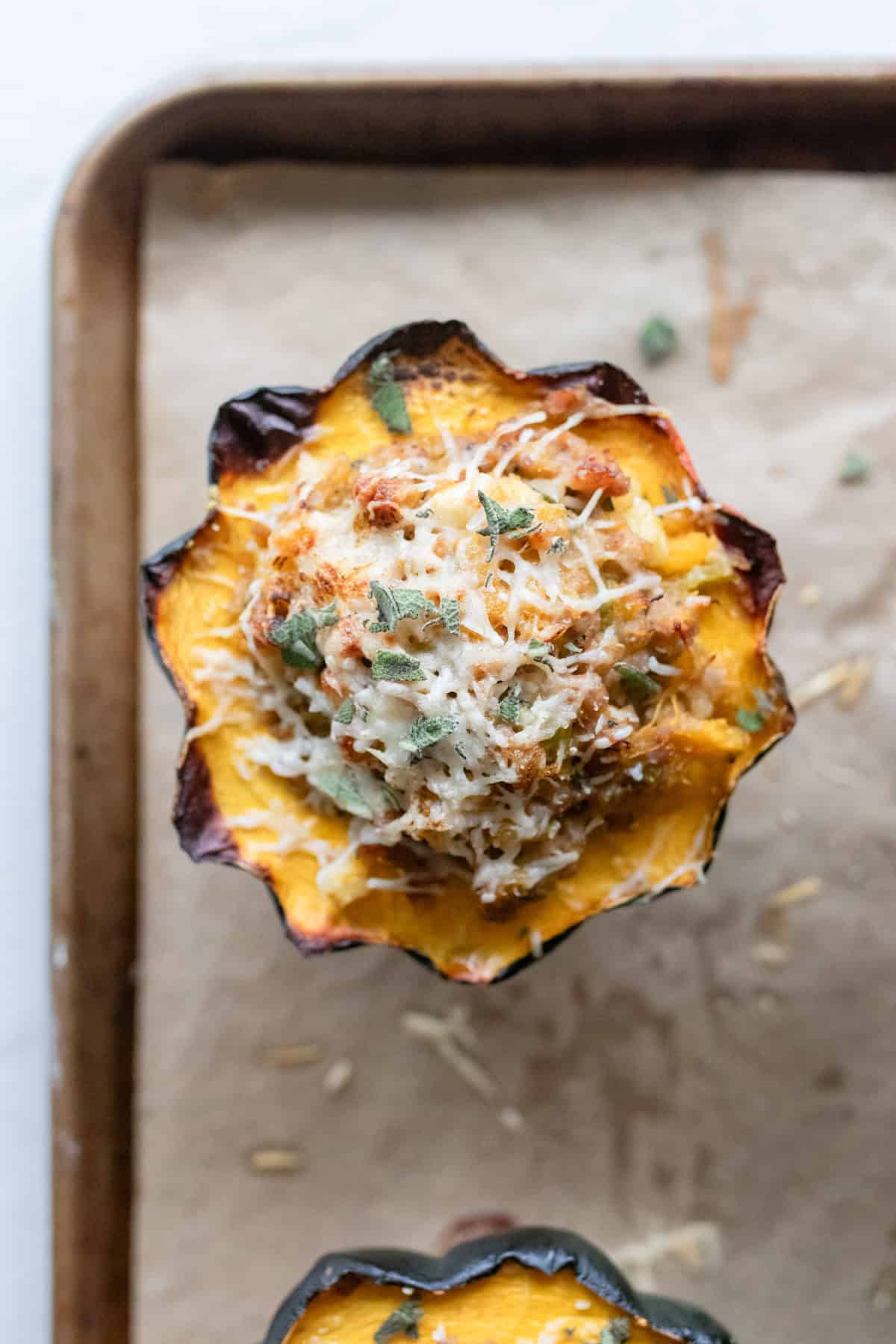 Baked stuffed acorn squash on a baking sheet.