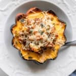 Stuffed acorn squash in a bowl.