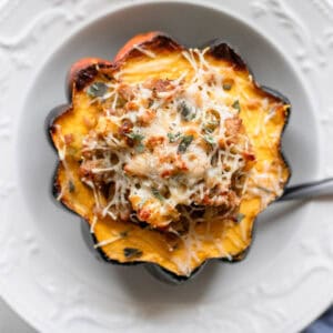 Stuffed acorn squash in a bowl.