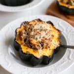 Stuffed acorn squash on a plate.