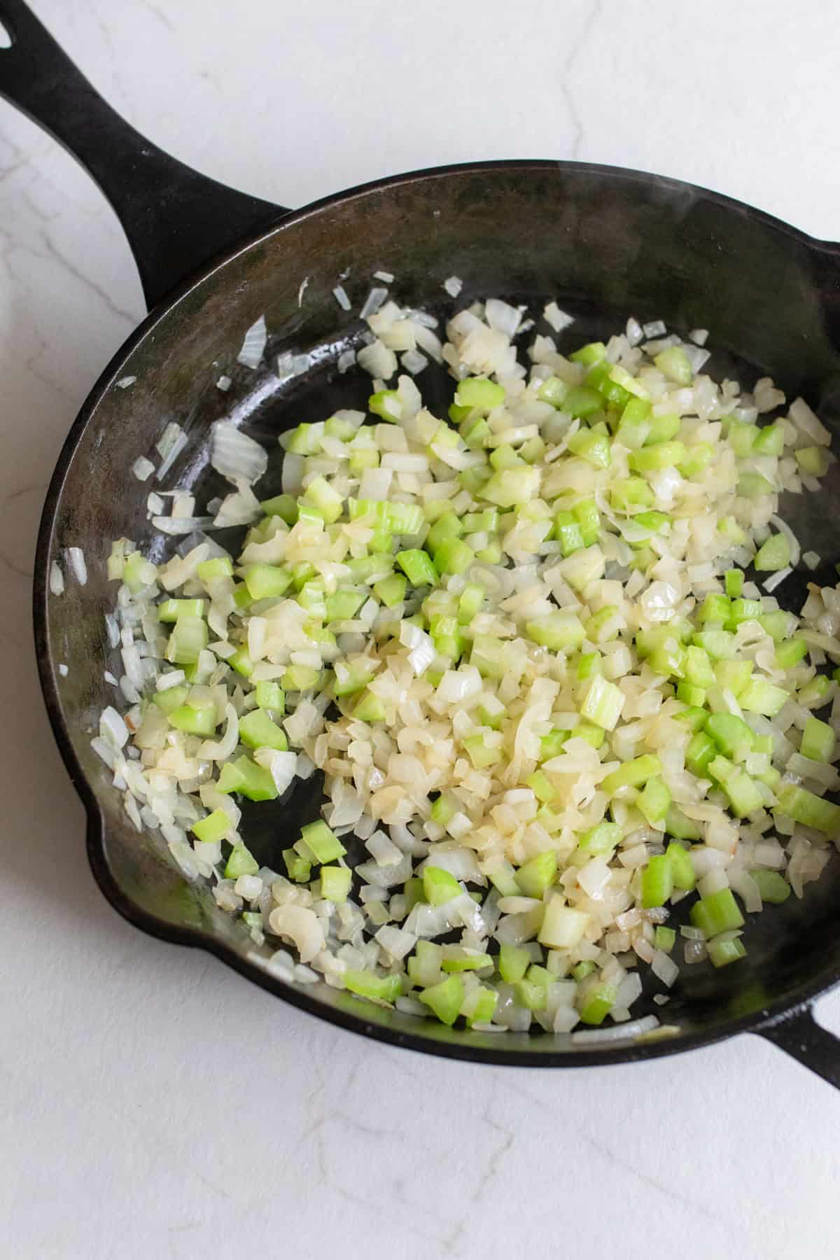 Veggies sautéed in a cast iron skillet.