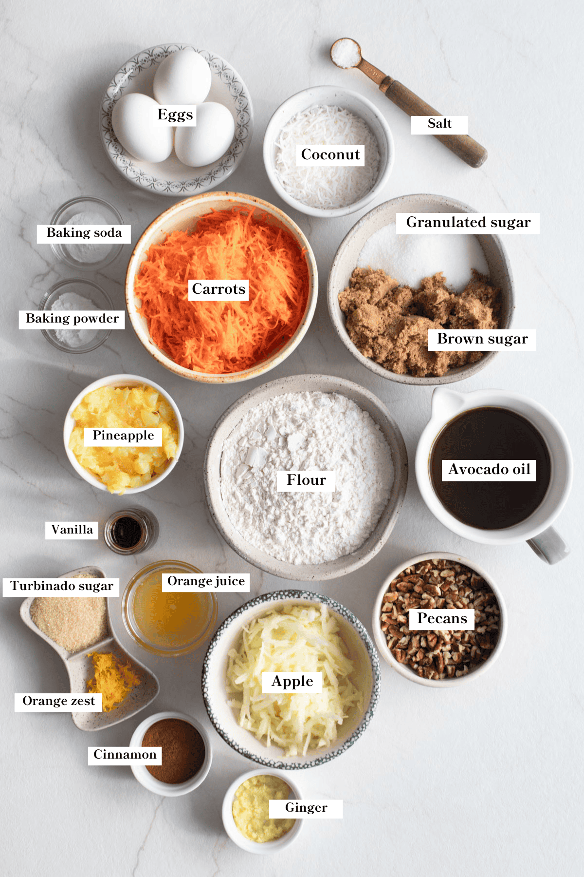 Ingredients for morning glory muffins in bowls on a counter.