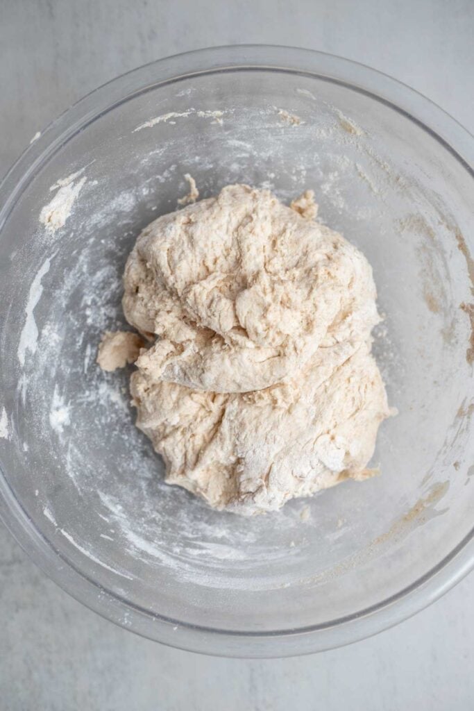 Spelt sourdough in a glass bowl mixed together for the autolyse process.