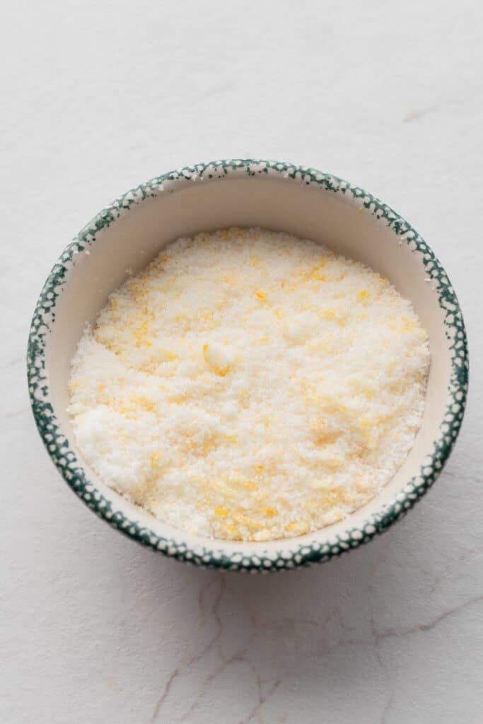 Lemon zest and sugar mixed together in a bowl.