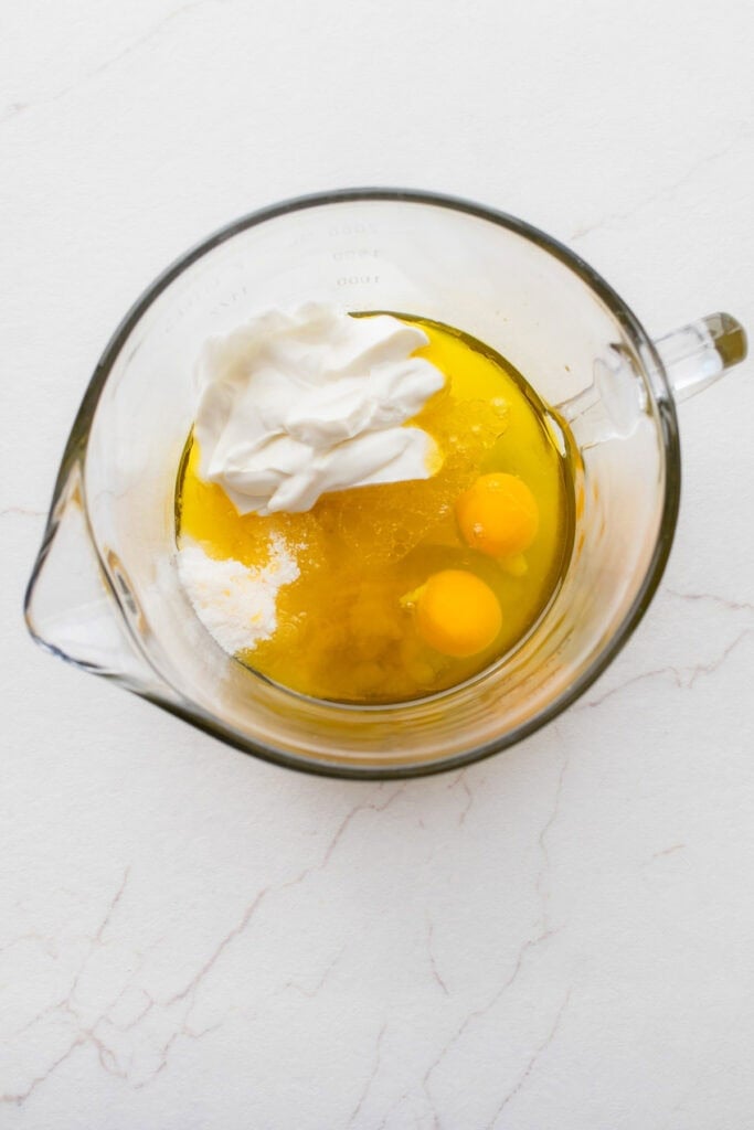 A glass bowl with eggs and yogurt.