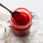 Sauce in a jar with a spoon.