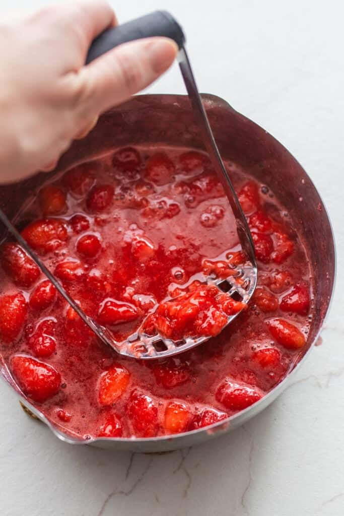 Potato masher in strawberry sauce.