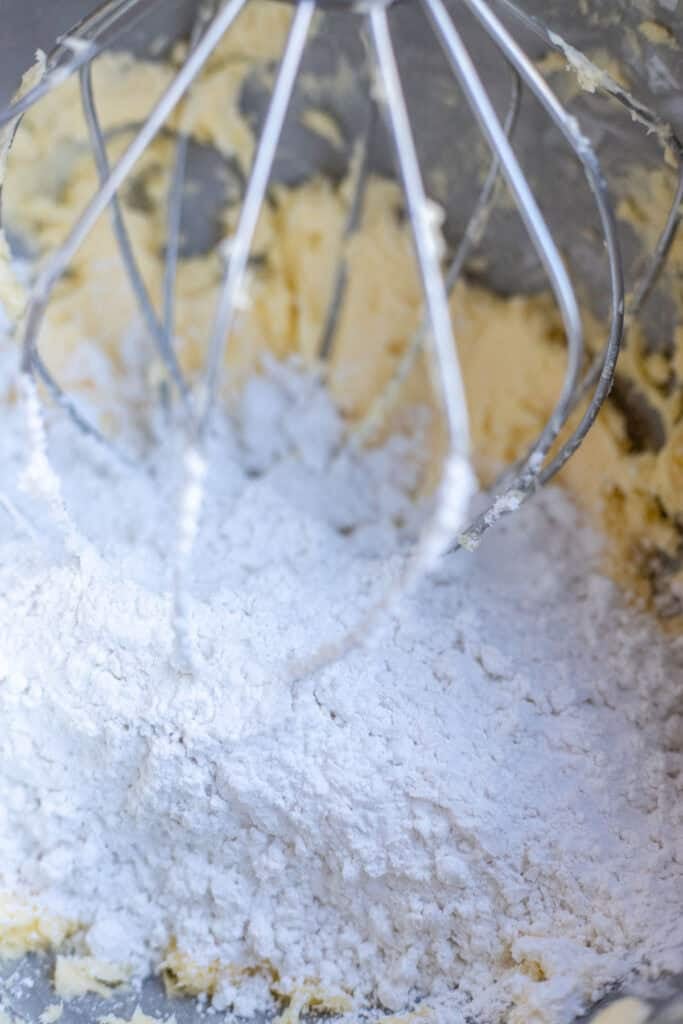 Creamed butter and powdered sugar in a stand mixer with a whisk.