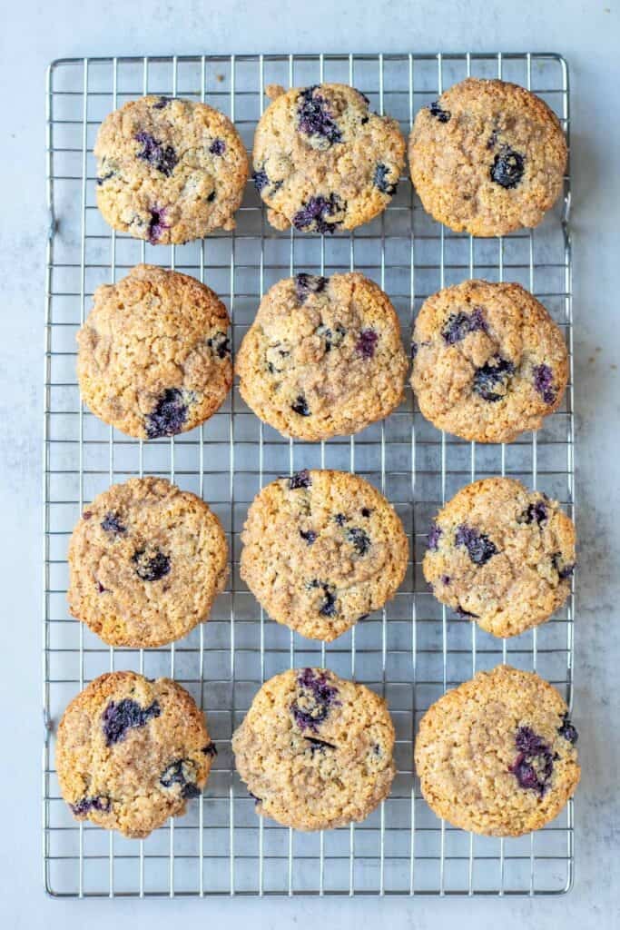 twelve blueberries muffins cooling on a wire wrack.