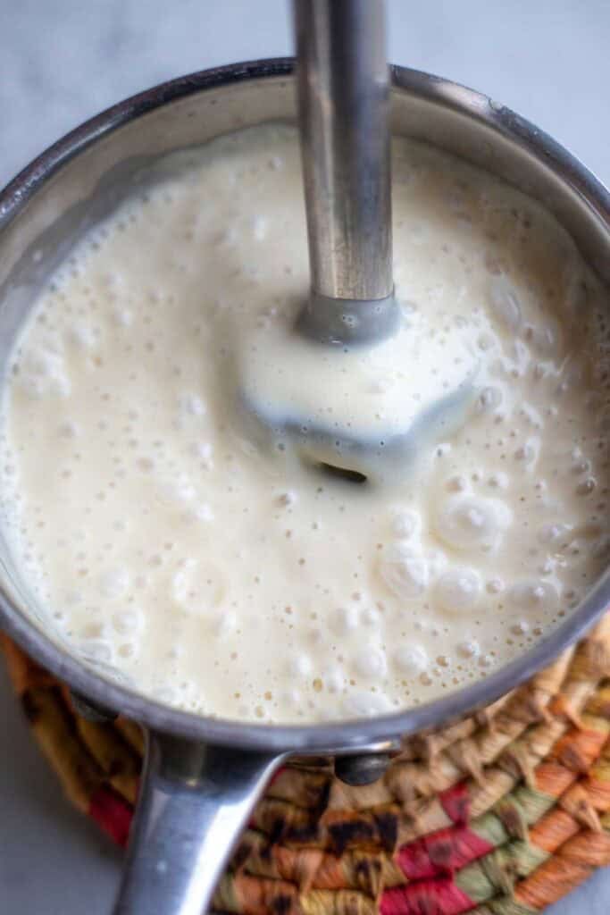 Frosting mixed together with an immersion blender.