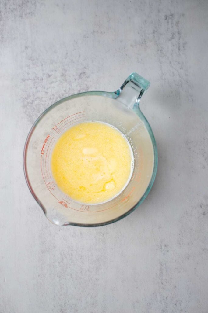 Melted butter in a glass measuring cup.