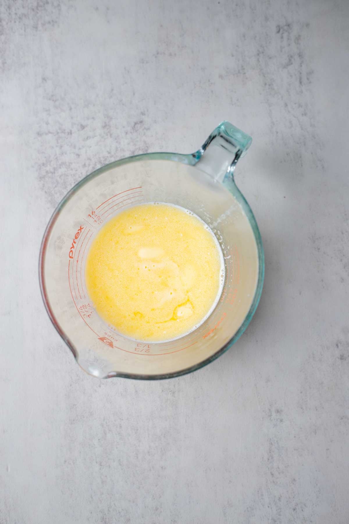Melted butter in a glass measuring cup. 
