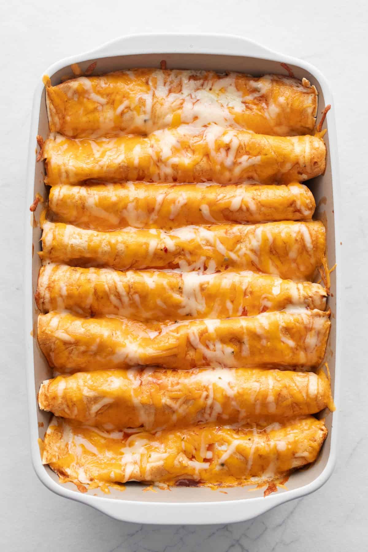 Baked enchiladas in a pan.