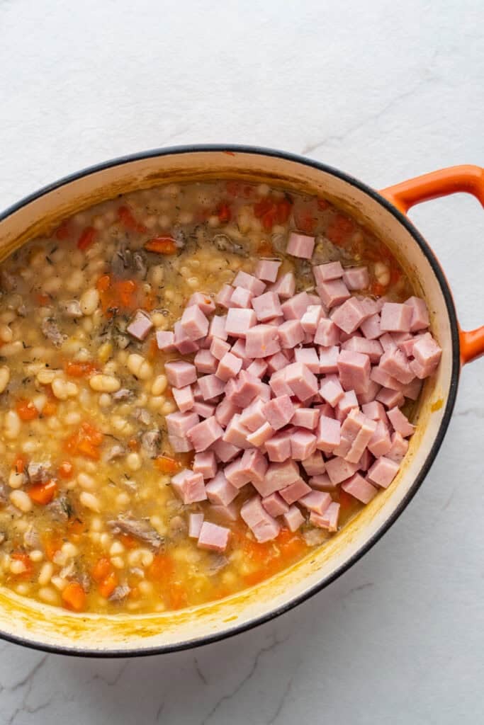 Diced ham added back to a soup pot of beans and broth.