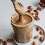Nut butter in a jar with a spoon.
