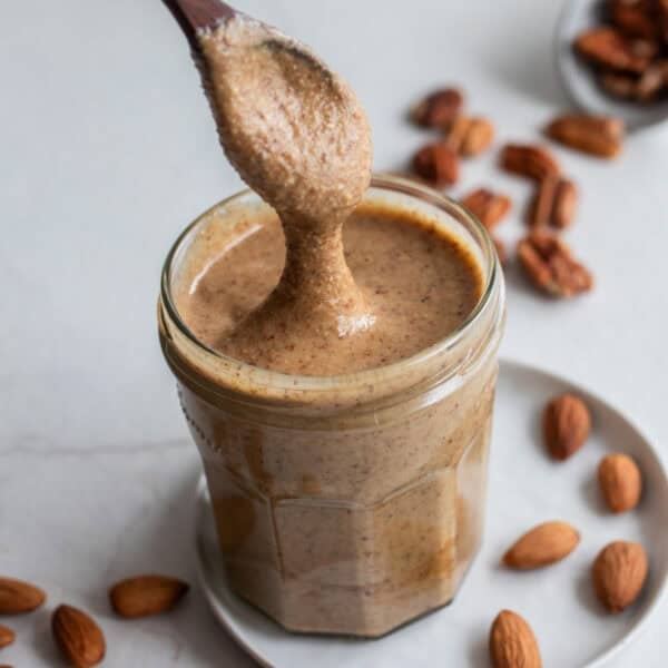 Nut butter in a jar with a spoon.