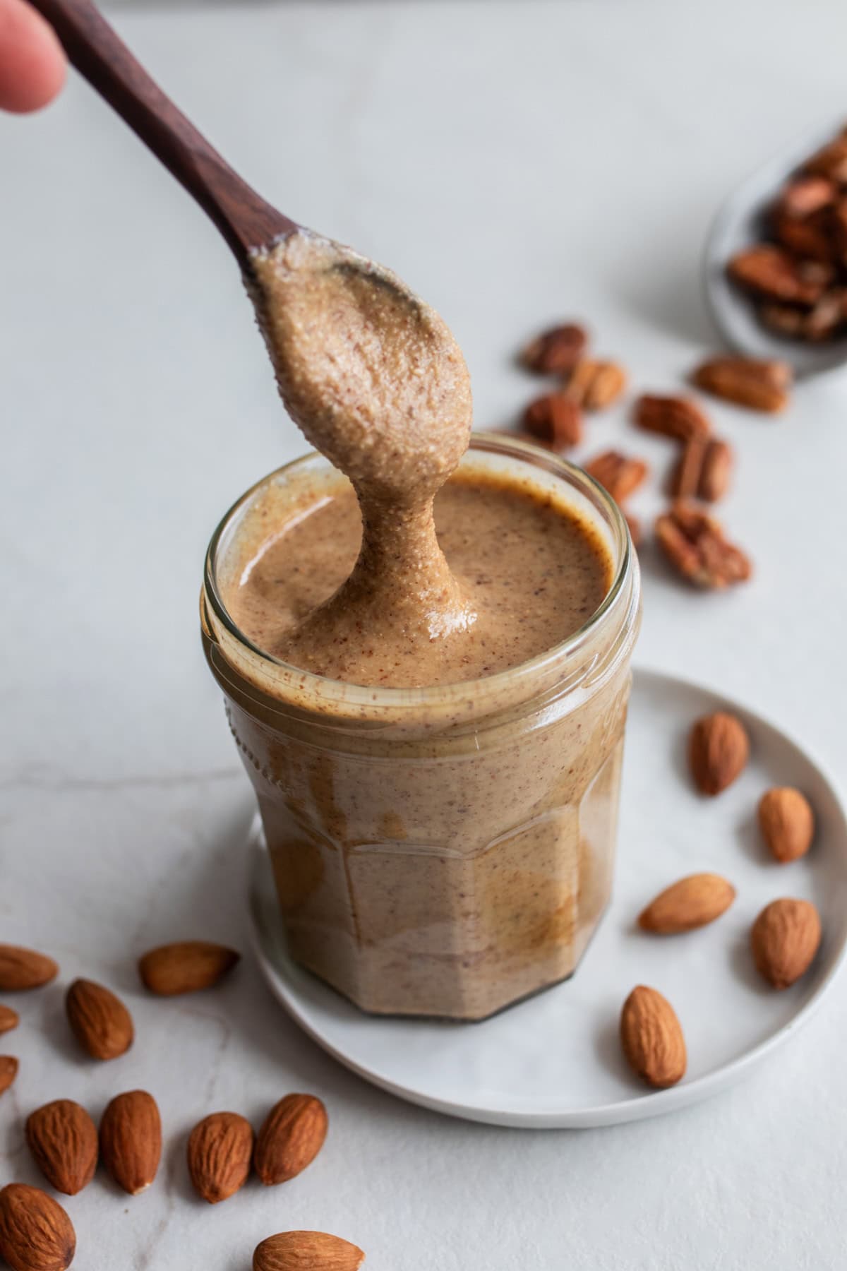 Nut butter in a jar with a spoon.