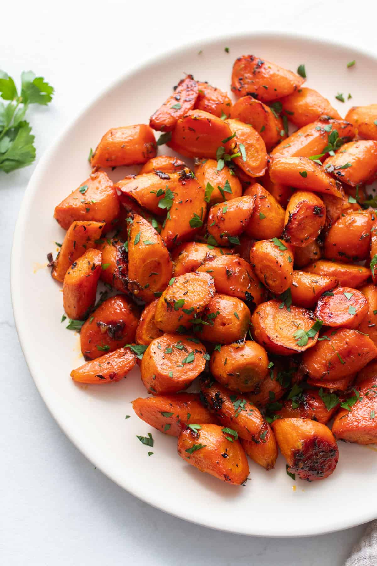 A plate full of carrots chopped into bite sized pieces.