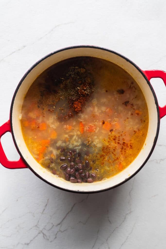 corn, black beans, and seasonings stirred into a dutch oven with the rest of the chicken soup.