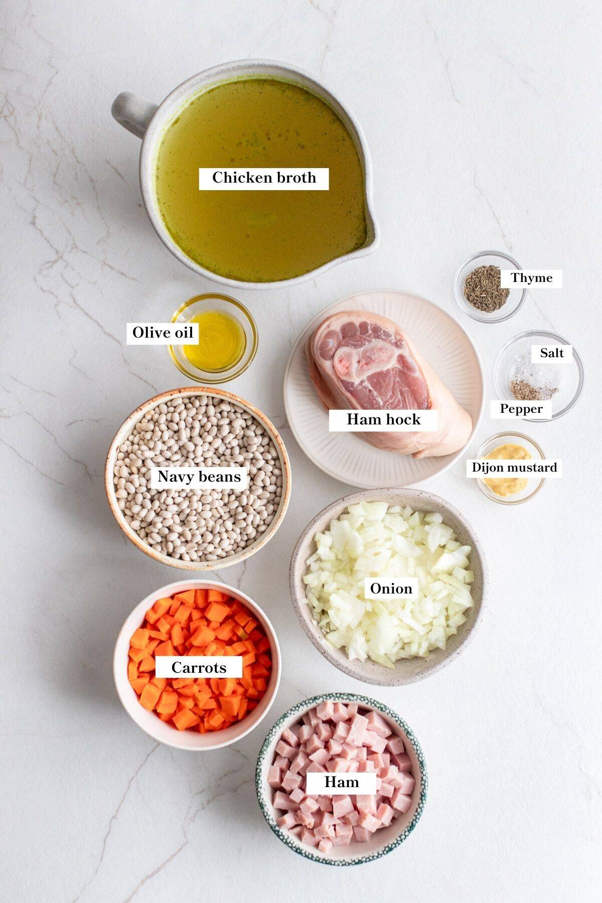 Ingredients for ham and bean soup on a kitchen counter.