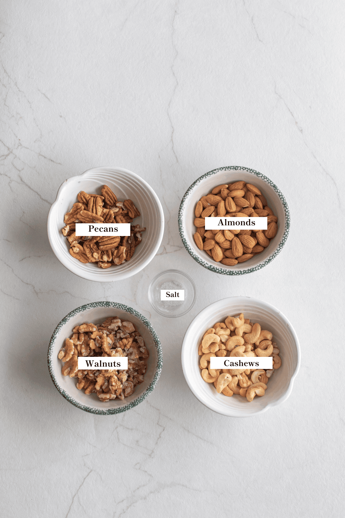 Bowls of nuts on a counter top.