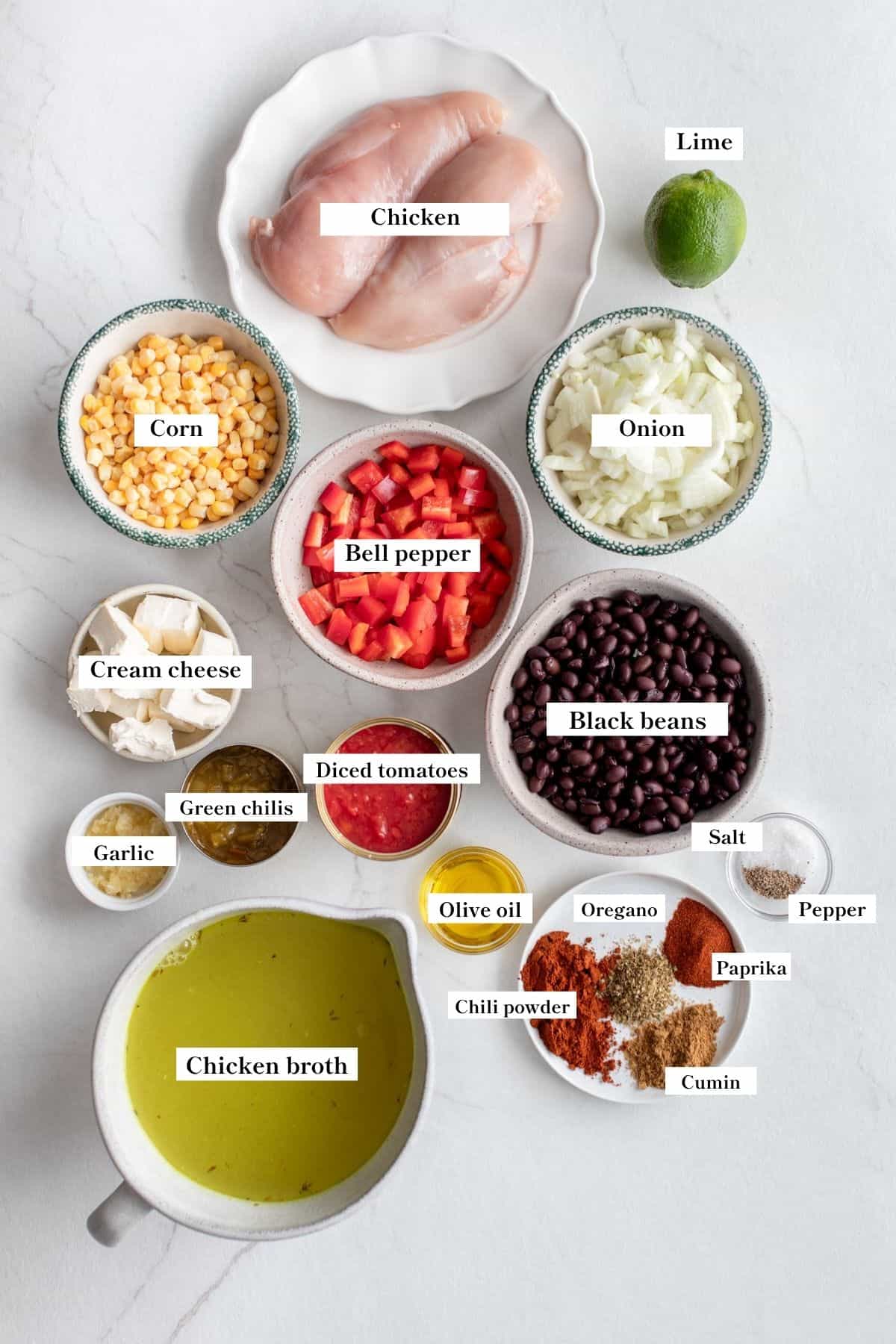 ingredients in small dishes on a marble counter for southwest chicken soup.