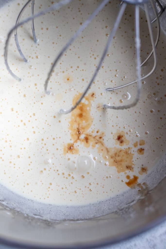 Vanilla added to the egg and sugar mixture in a stand mixer.