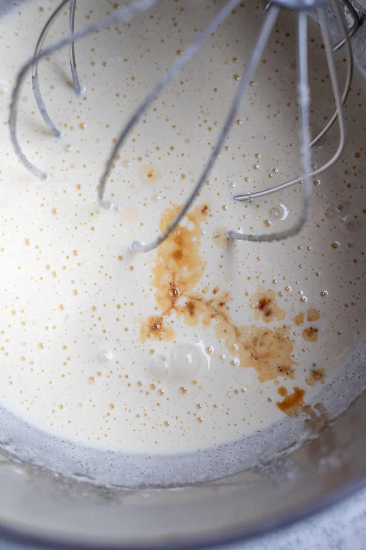 Vanilla added to the egg and sugar mixture in a stand mixer.